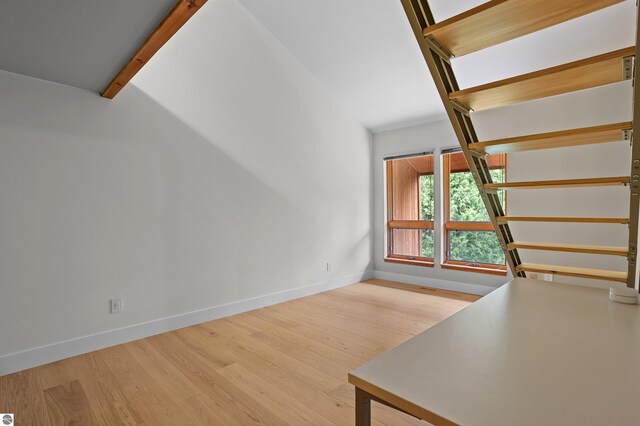 4340 E Huron River Dr, Ann Arbor, MI 48105 - unfurnished living room featuring baseboards and wood finished floors