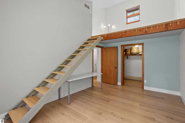 4340 E Huron River Dr, Ann Arbor, MI 48105 - staircase with a towering ceiling and wood finished floors