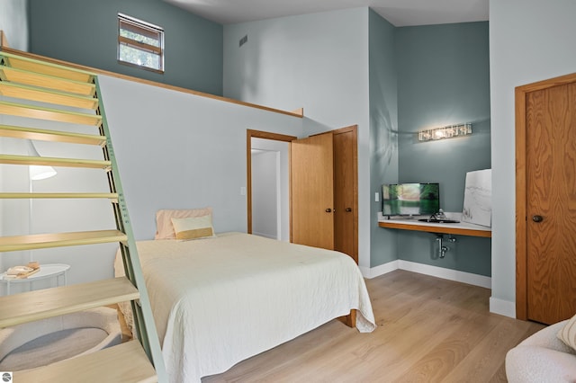 4340 E Huron River Dr, Ann Arbor, MI 48105 - bedroom featuring wood finished floors, a high ceiling, and built in study area