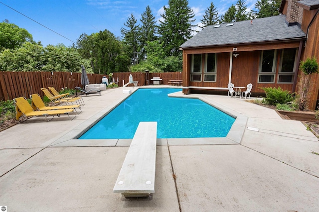 4340 E Huron River Dr, Ann Arbor, MI 48105 - view of swimming pool featuring a diving board, a patio area, and a fenced backyard