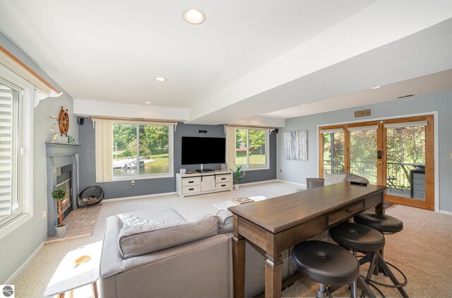 7746 Five Lakes Dr, Farwell, MI 48622 - carpeted living area with french doors, a glass covered fireplace, plenty of natural light, and recessed lighting