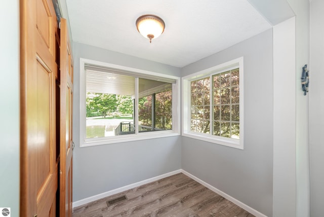 7746 Five Lakes Dr, Farwell, MI 48622 - empty room with healthy amount of natural light and wood finished floors