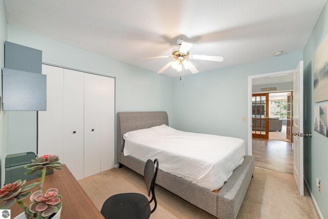 7746 Five Lakes Dr, Farwell, MI 48622 - bedroom with a closet, light colored carpet, and ceiling fan