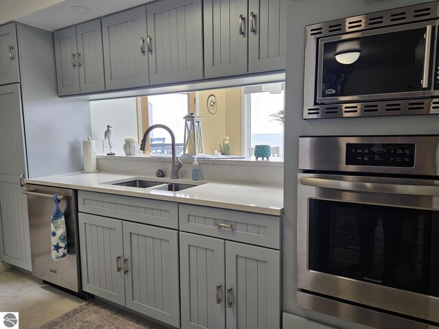 407 W Lake St Unit 45, Tawas City, MI 48763 - kitchen with stainless steel appliances and gray cabinets