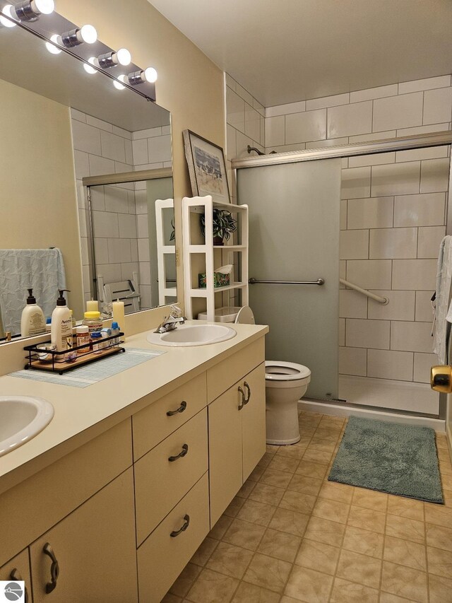 407 W Lake St Unit 45, Tawas City, MI 48763 - full bathroom featuring double vanity, a shower stall, and tile patterned floors