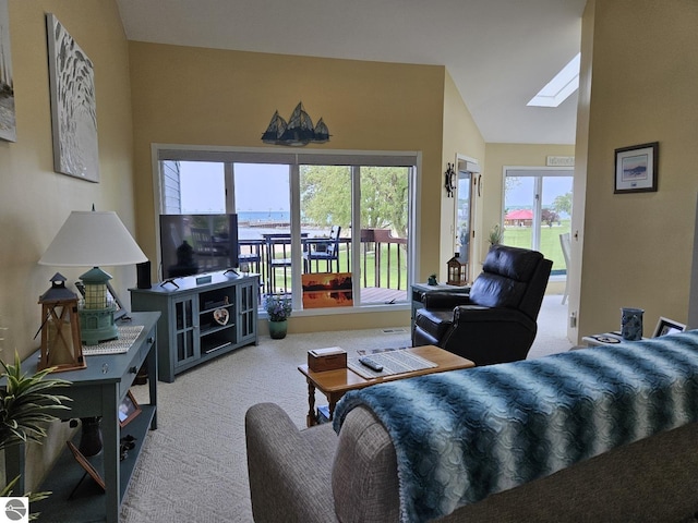 407 W Lake St Unit 45, Tawas City, MI 48763 - carpeted living room with plenty of natural light, a skylight, and vaulted ceiling