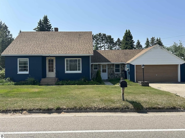 501 W 13th St, Cadillac, MI 49601 - view of front of house featuring a front lawn, driveway, roof with shingles, and an attached garage