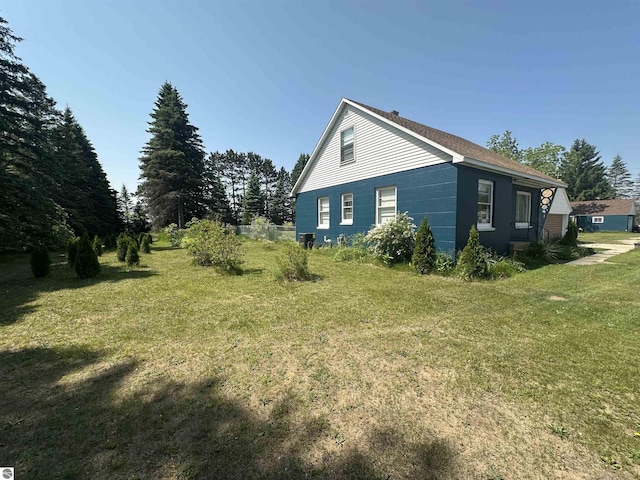 501 W 13th St, Cadillac, MI 49601 - view of home's exterior featuring a yard
