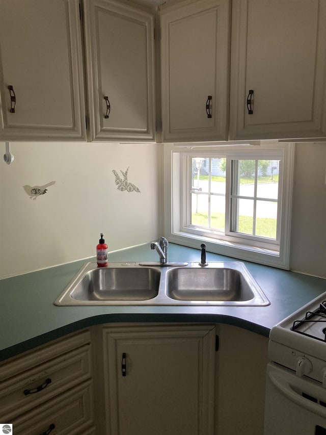 4510 W Country Way, Saginaw, MI 48603 - kitchen featuring white range with gas stovetop and dark countertops