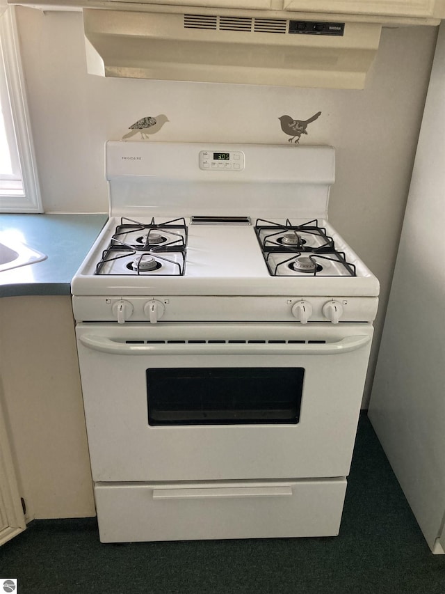 4510 W Country Way, Saginaw, MI 48603 - kitchen with white range with gas cooktop, carpet, and extractor fan