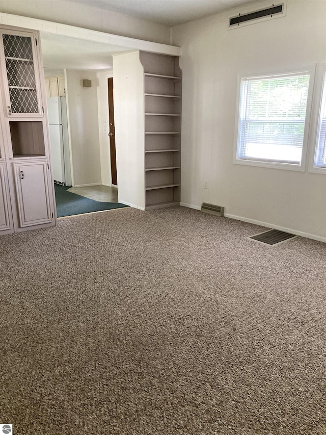 4510 W Country Way, Saginaw, MI 48603 - unfurnished bedroom featuring freestanding refrigerator and carpet
