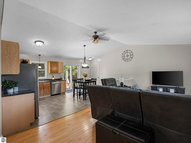 1708 Ketha Dr, Cadillac, MI 49601 - living room featuring light wood-style flooring, ceiling fan, and lofted ceiling