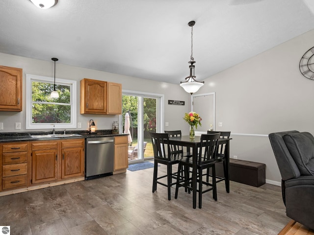 1708 Ketha Dr, Cadillac, MI 49601 - kitchen with dishwasher, dark countertops, decorative light fixtures, open floor plan, and brown cabinets