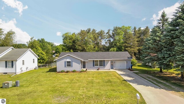 1708 Ketha Dr, Cadillac, MI 49601 - ranch-style home featuring a garage, driveway, and view of scattered trees