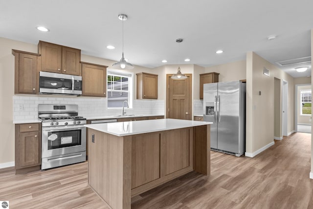 3874 Falling Leaf Trl, Traverse City, MI 49686 - kitchen featuring stainless steel appliances, a kitchen island, light wood-type flooring, light countertops, and recessed lighting