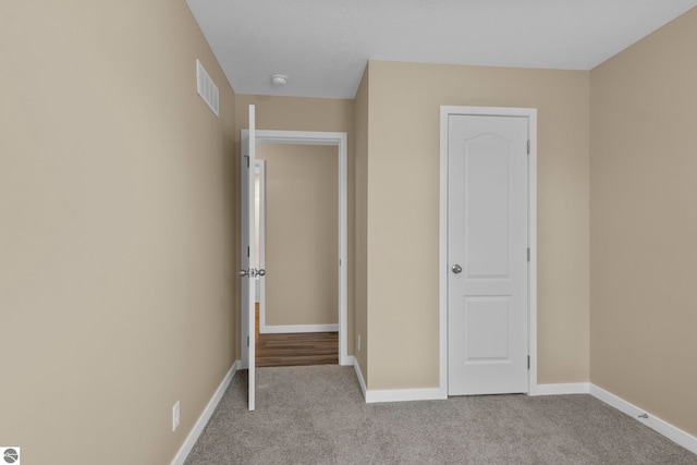 3874 Falling Leaf Trl, Traverse City, MI 49686 - unfurnished bedroom featuring carpet flooring and baseboards