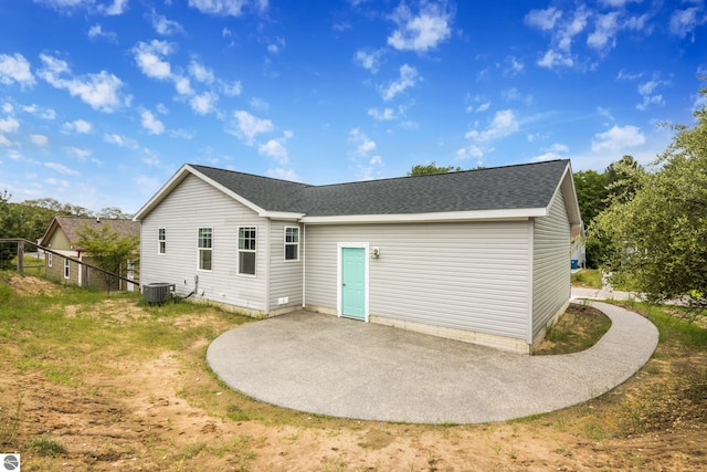 3874 Falling Leaf Trl, Traverse City, MI 49686 - rear view of house featuring a patio area and a shingled roof