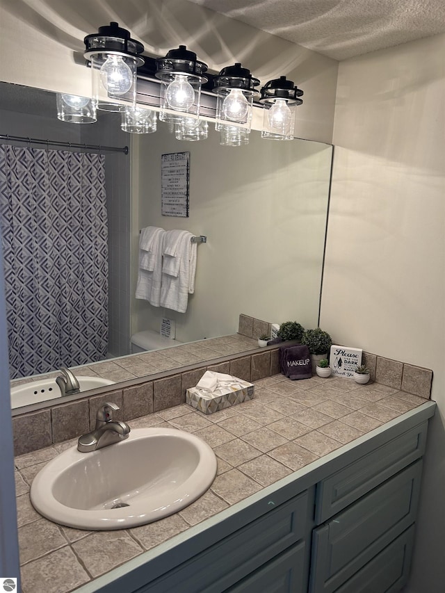4673 N Crossover Dr, Bellaire, MI 49615 - full bathroom with vanity, a textured ceiling, and a shower with shower curtain