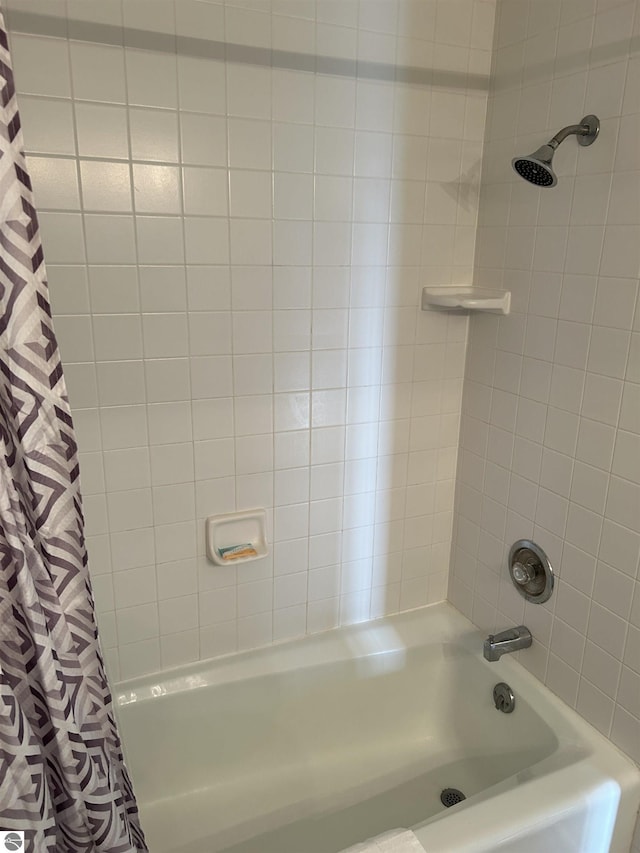 4673 N Crossover Dr, Bellaire, MI 49615 - bathroom featuring shower / bath combo with shower curtain