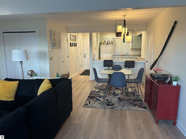 4673 N Crossover Dr, Bellaire, MI 49615 - dining space with light wood-style flooring and baseboards