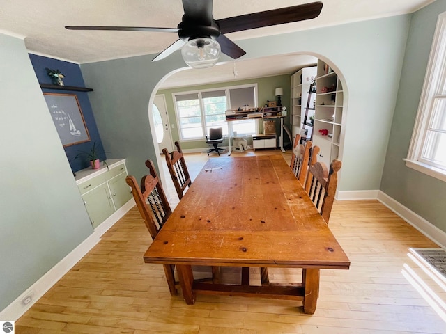 801 N Bridge St, Bellaire, MI 49615 - dining area with arched walkways, hardwood / wood-style flooring, ceiling fan, and plenty of natural light