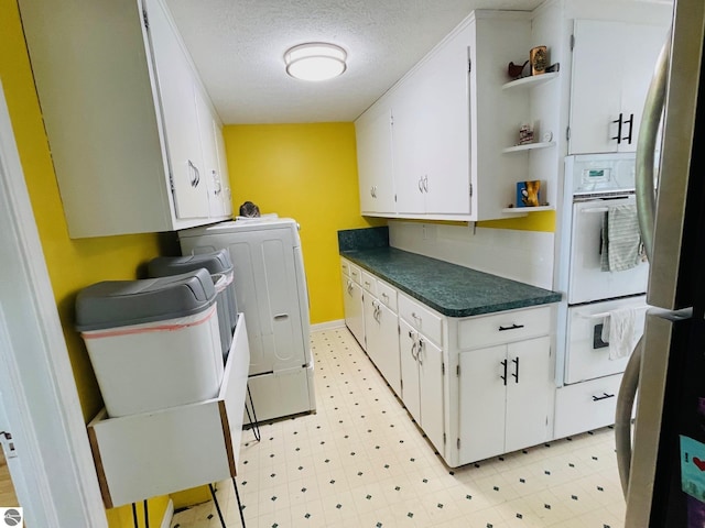 801 N Bridge St, Bellaire, MI 49615 - washroom with light floors, cabinet space, and a textured ceiling