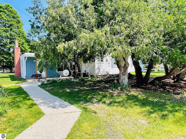801 N Bridge St, Bellaire, MI 49615 - view of property hidden behind natural elements with a front yard