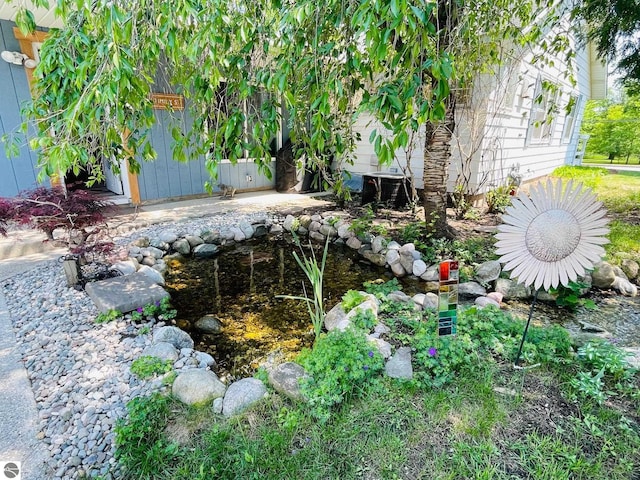 801 N Bridge St, Bellaire, MI 49615 - view of yard featuring a garden pond