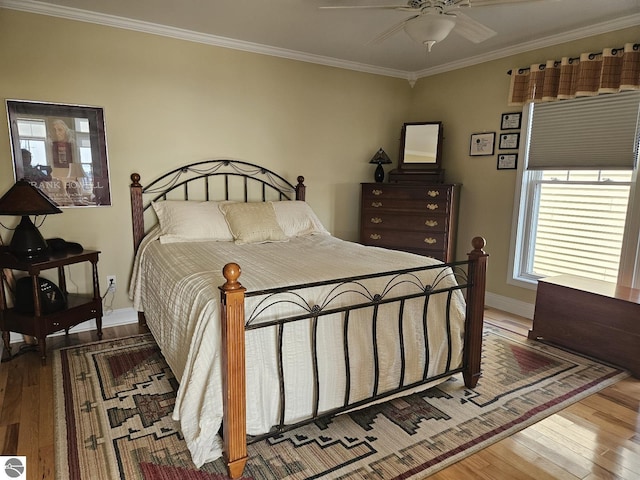 1005 W Lake St Unit 4, Tawas City, MI 48763 - bedroom featuring wood finished floors, ornamental molding, and a ceiling fan