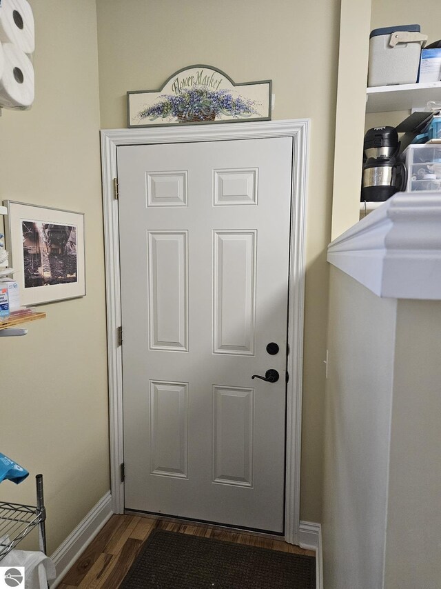 1005 W Lake St Unit 4, Tawas City, MI 48763 - doorway featuring dark wood finished floors and baseboards