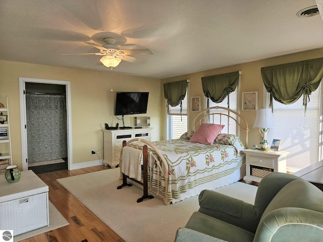 1005 W Lake St Unit 4, Tawas City, MI 48763 - bedroom with wood finished floors and a ceiling fan