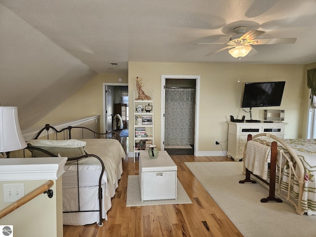 1005 W Lake St Unit 4, Tawas City, MI 48763 - bedroom with wood finished floors, vaulted ceiling, and a ceiling fan