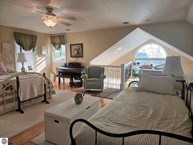 1005 W Lake St Unit 4, Tawas City, MI 48763 - bedroom featuring wood finished floors, vaulted ceiling, and a ceiling fan