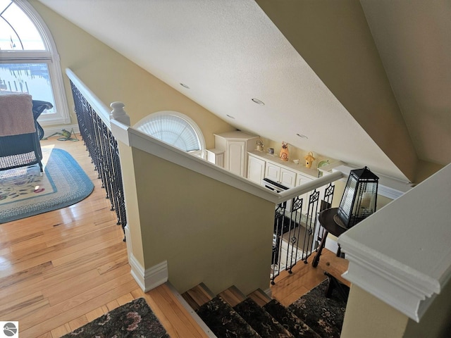 1005 W Lake St Unit 4, Tawas City, MI 48763 - stairs featuring hardwood / wood-style flooring and baseboards