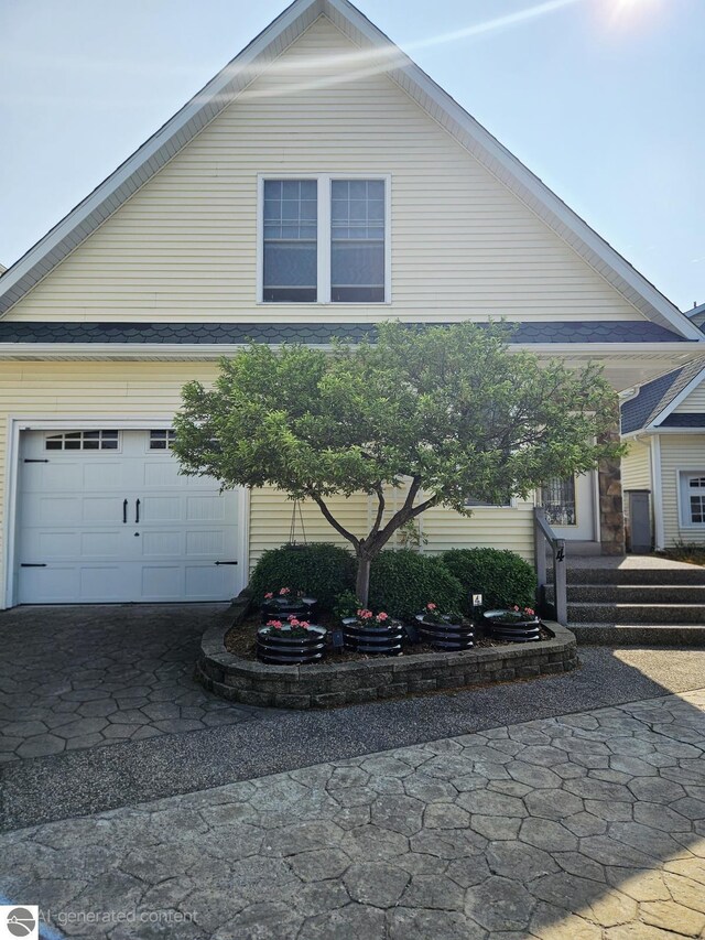 1005 W Lake St Unit 4, Tawas City, MI 48763 - view of side of property featuring a garage and asphalt driveway