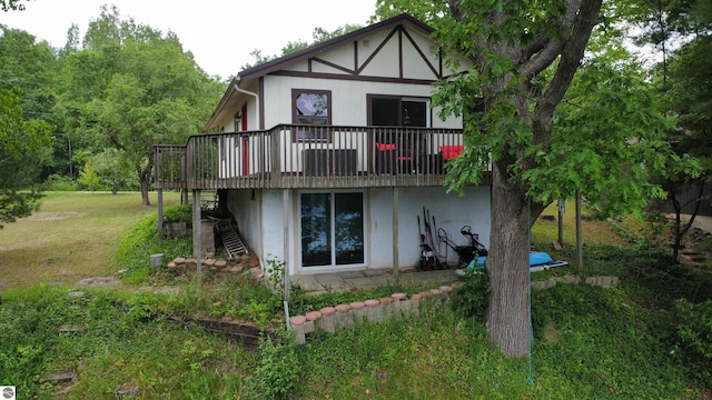 7500 Five Lakes Dr, Farwell, MI 48622 - rear view of property with a wooden deck, a lawn, stairs, and stucco siding