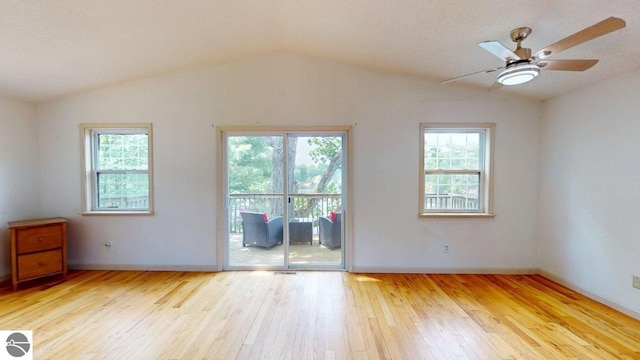 7500 Five Lakes Dr, Farwell, MI 48622 - empty room with vaulted ceiling, hardwood / wood-style floors, healthy amount of natural light, and a ceiling fan