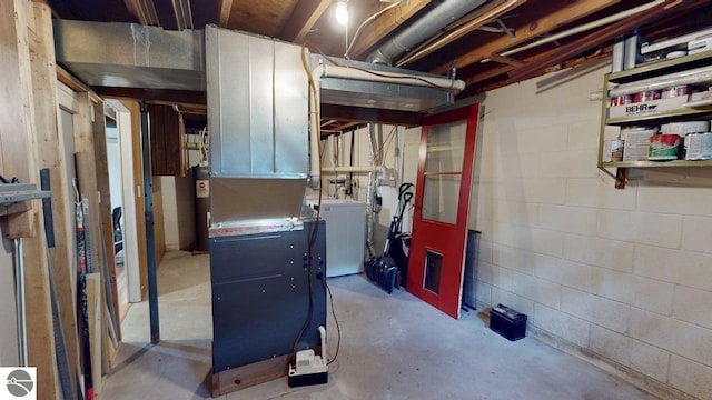 7500 Five Lakes Dr, Farwell, MI 48622 - unfinished below grade area with water heater, independent washer and dryer, and concrete block wall