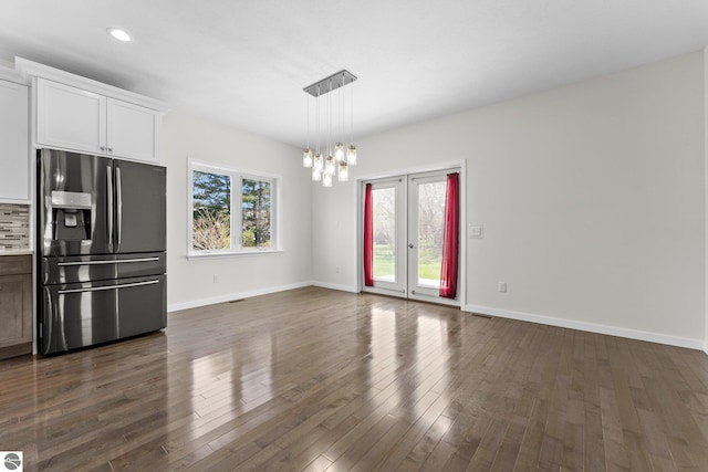 301 Pearl St, Kingsley, MI 49649 - kitchen with stainless steel fridge with ice dispenser, a chandelier, dark wood-style flooring, light countertops, and white cabinets