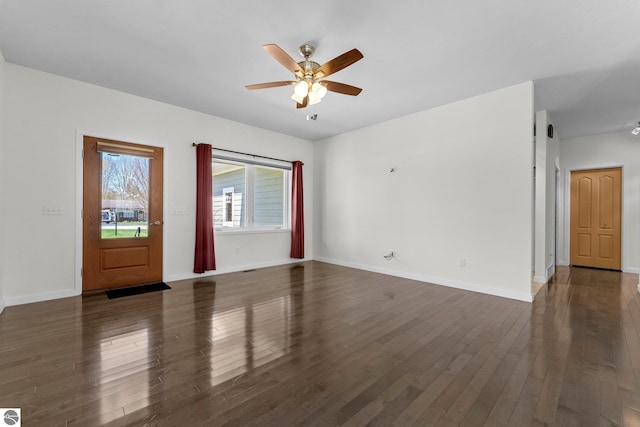 301 Pearl St, Kingsley, MI 49649 - unfurnished living room featuring ceiling fan and dark wood finished floors