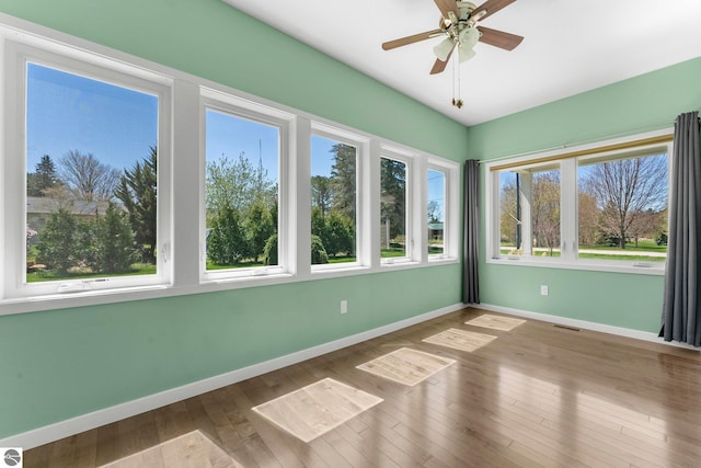 301 Pearl St, Kingsley, MI 49649 - unfurnished sunroom with baseboards and wood finished floors