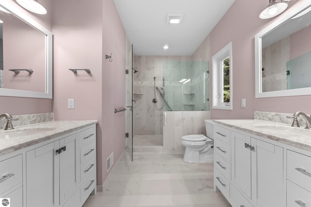 301 Pearl St, Kingsley, MI 49649 - bathroom featuring a marble finish shower, marble look tiles, two vanities, and recessed lighting