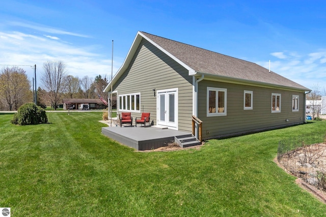 301 Pearl St, Kingsley, MI 49649 - rear view of property with a lawn, a shingled roof, and french doors