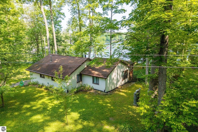16530 Lonesome Trl, Leroy, MI 49655 - view of home's exterior with roof with shingles and a lawn