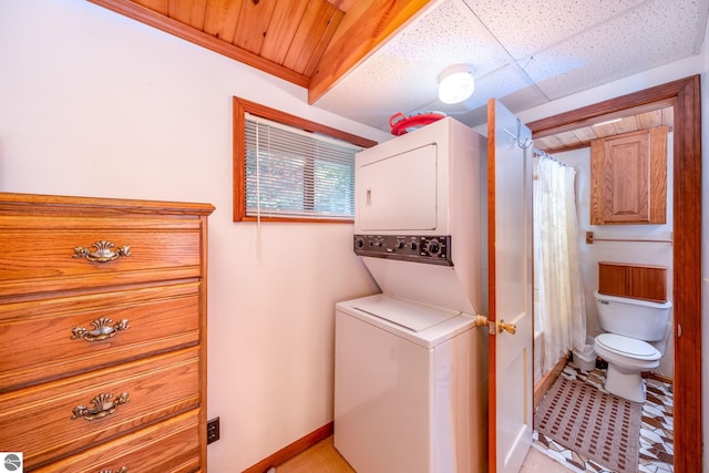 16530 Lonesome Trl, Leroy, MI 49655 - laundry room featuring stacked washing machine and dryer and baseboards