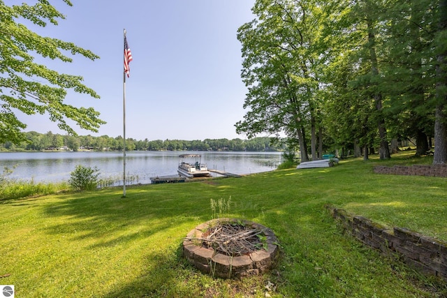 16530 Lonesome Trl, Leroy, MI 49655 - view of green lawn featuring a dock and a water view