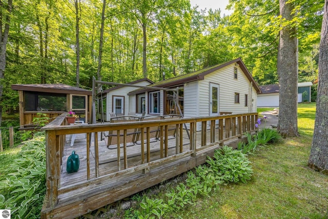 16530 Lonesome Trl, Leroy, MI 49655 - rear view of property featuring a wooden deck and an outbuilding