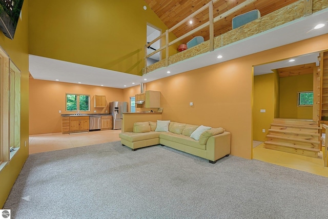 1849 W 24th Rd, Boon, MI 49618 - living room featuring a towering ceiling, light carpet, recessed lighting, wood ceiling, and stairs
