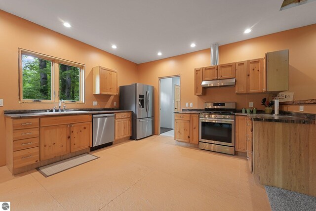 1849 W 24th Rd, Boon, MI 49618 - kitchen featuring appliances with stainless steel finishes, under cabinet range hood, dark countertops, and recessed lighting
