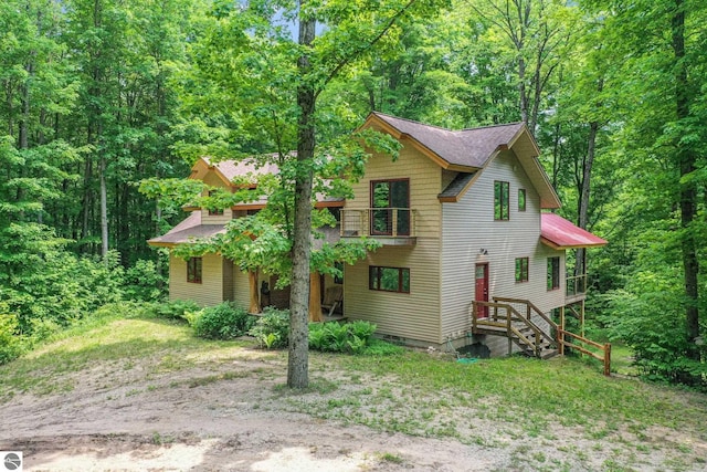 1849 W 24th Rd, Boon, MI 49618 - view of front of home with a wooded view and roof with shingles